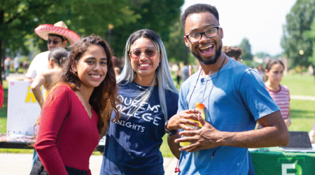 Group of three students smiling at the camera